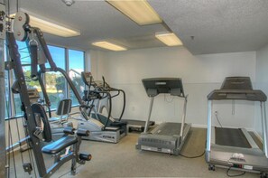 A gym with cardio equipment including treadmills, an elliptical, and a stationary bike.