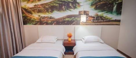 A hotel room with two beds, a mural of a landscape on the wall, and a nightstand with a vase of flowers.