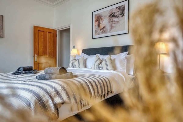 Bedroom with a king bed and a dedicated workspace at Blue Puffin Stays Short Lets & Serviced Accommodation