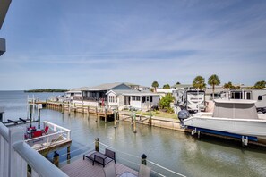 Relax by the water's edge at this serene waterfront property, where a dock offers a peaceful seating area and access to the water.