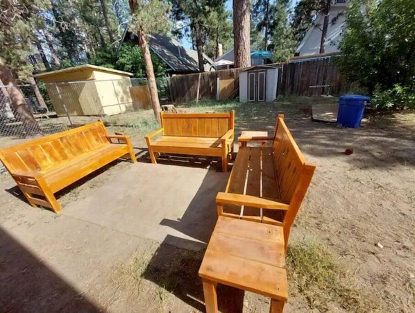 Sit and unwind in an outdoor space with a bench and table.