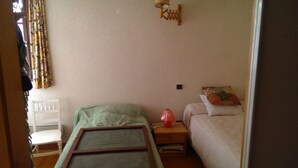 A bedroom with a bed, bedside table, and a lamp.
