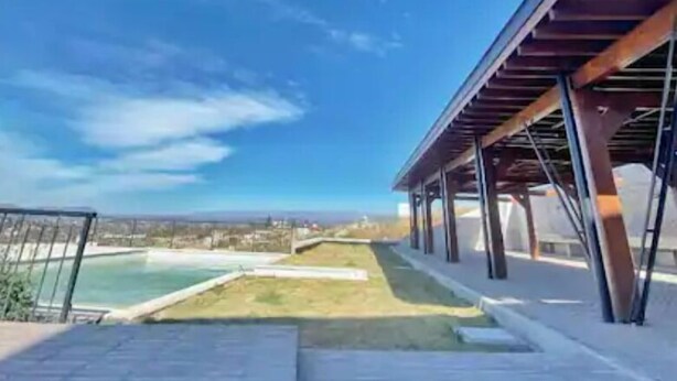 A covered outdoor area with a view of a distant landscape.
