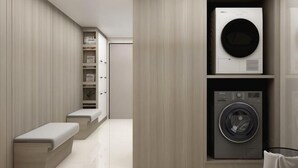 A modern laundry room with built-in appliances, a bench, and storage shelves. - Dongrong Hotel (Dongguan Municipal Government International Trade Center) (Dongguan)