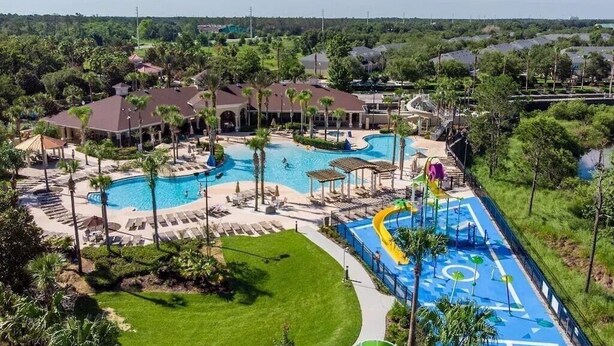 A resort with a large swimming pool, sun loungers, and a water slide. - Sunset view next to Waterpark/Pool. Moana, Beauty&Beast, etc. theme Near Disney. (Kissimmee)