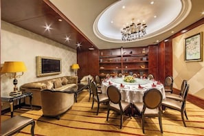 A formal dining room with a round table, chairs, and a chandelier. - Binjiang International Hotel (Tengzhou)