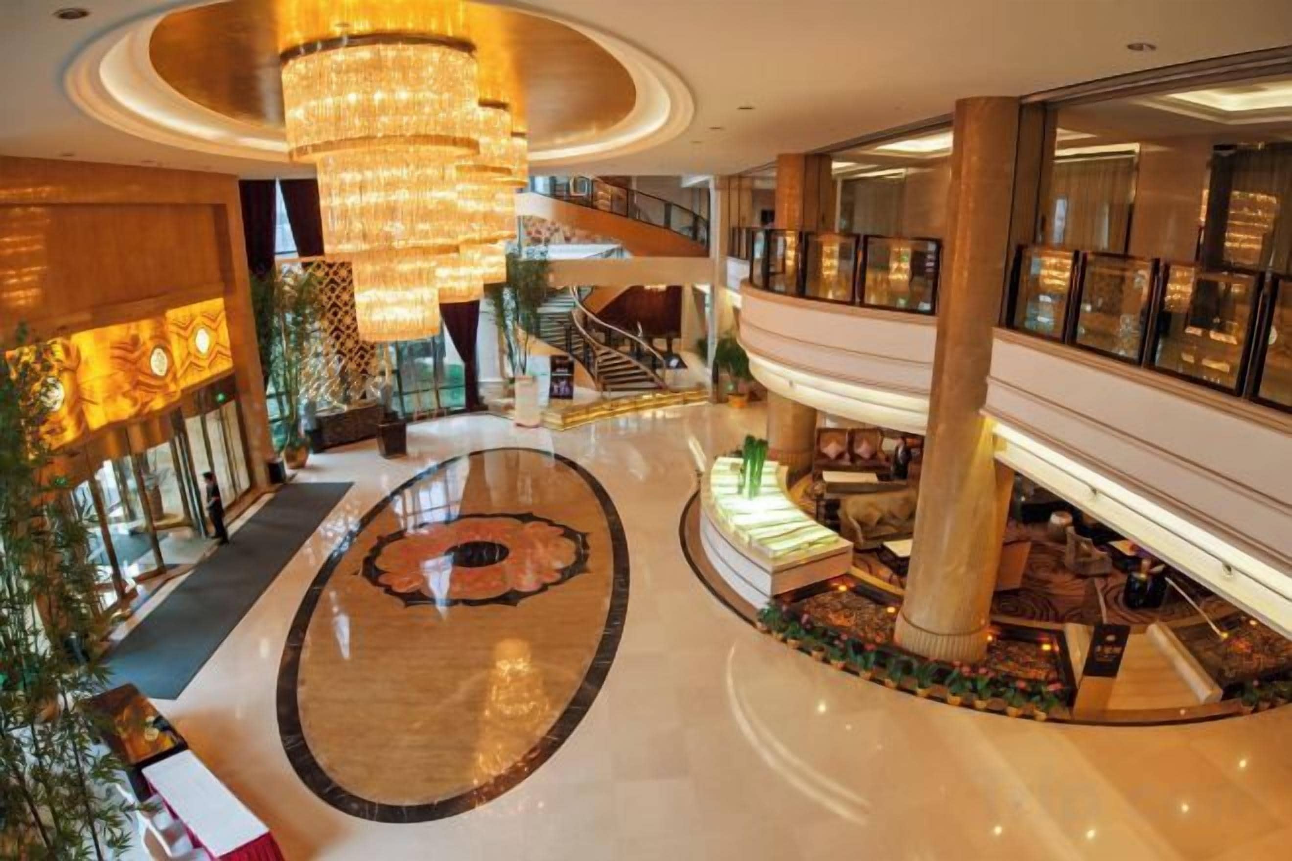 A spacious atrium with a central circular area, multiple levels, and a grand chandelier.