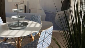 A dining area with a round table, patterned chairs, and a wall mural. - Cozy, bright 2BD w/yard, close to DT-bikes avail! (Manassas)