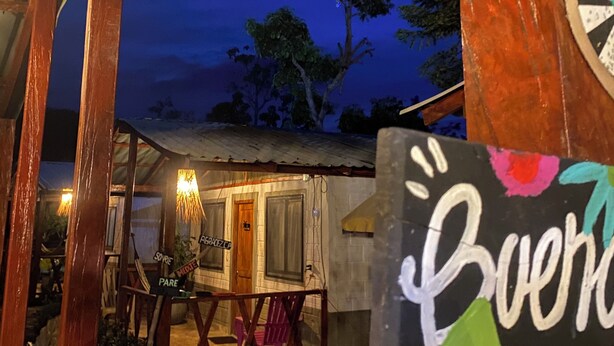 A rustic wooden structure with a sign reading "Bueno" and a dartboard. - Las Rocas Village Ecohotel  (Acandi)