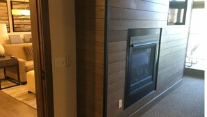 A modern interior with a fireplace, a sofa, and a coffee table. - Surrounded by pine trees and mountains (Truckee)