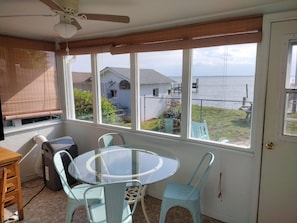 Enjoy a serene view of the water from this room's large window, which looks out onto a dock.
