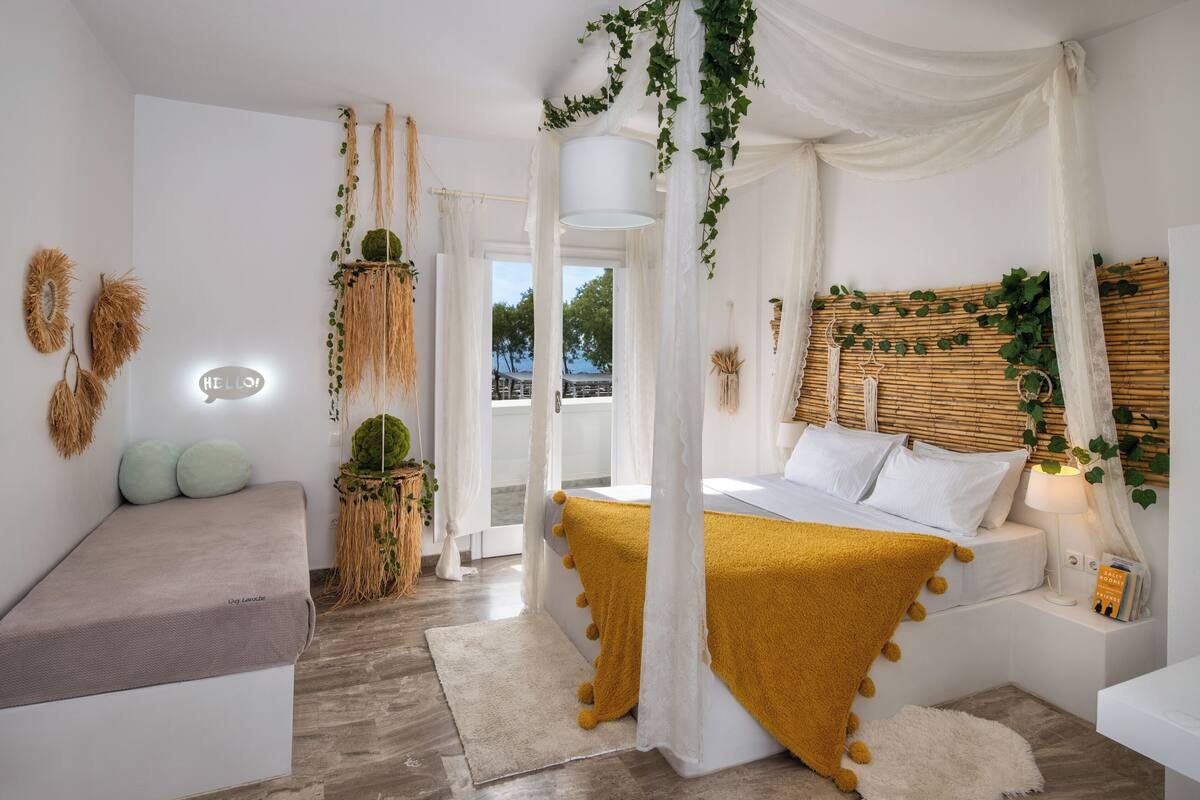 A modern bedroom with a bed, bedside table, and a bench.