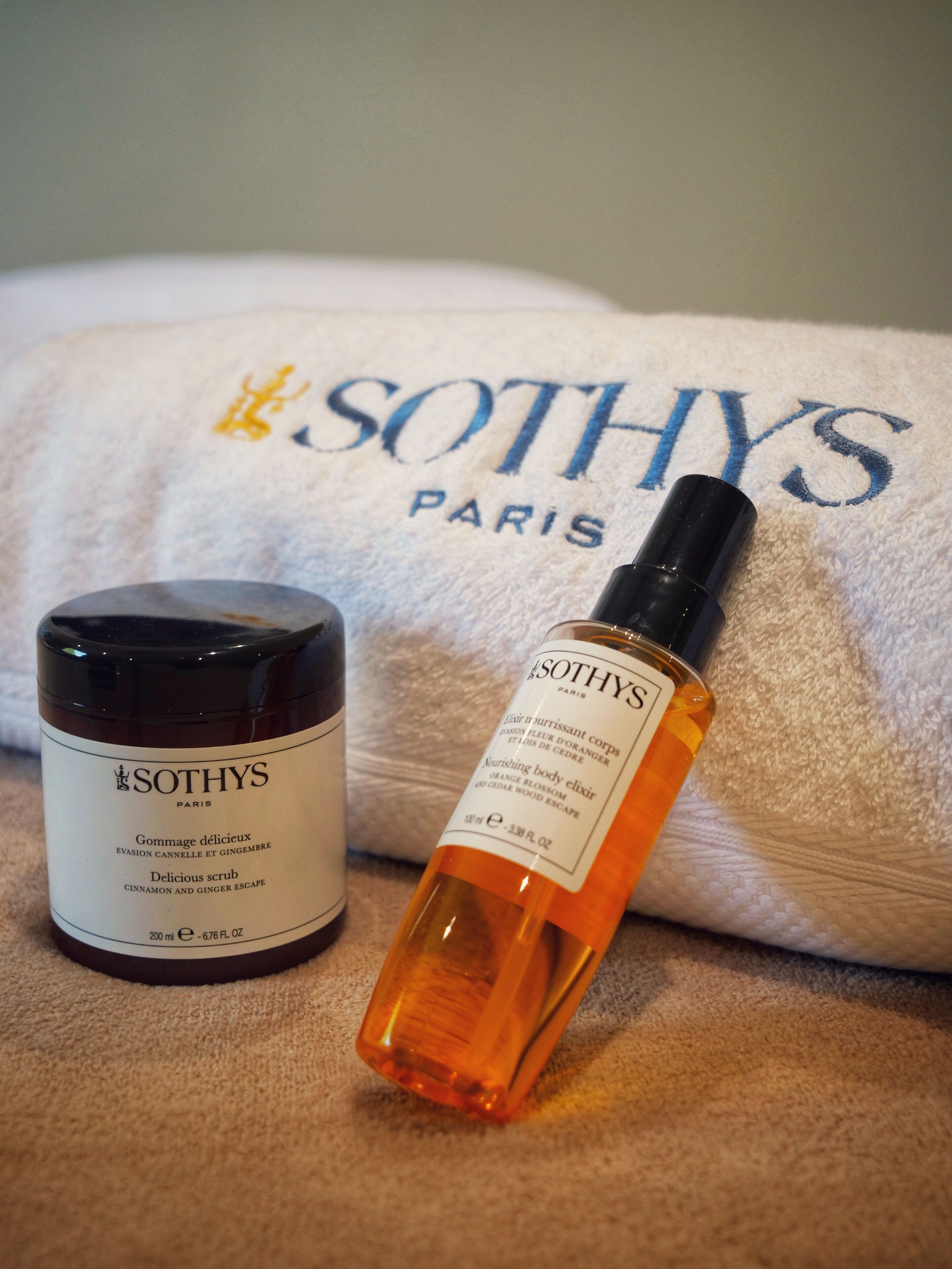 A bottle of Sothys Paris orange body elixir and a jar of Sothys Paris citrus body scrub.