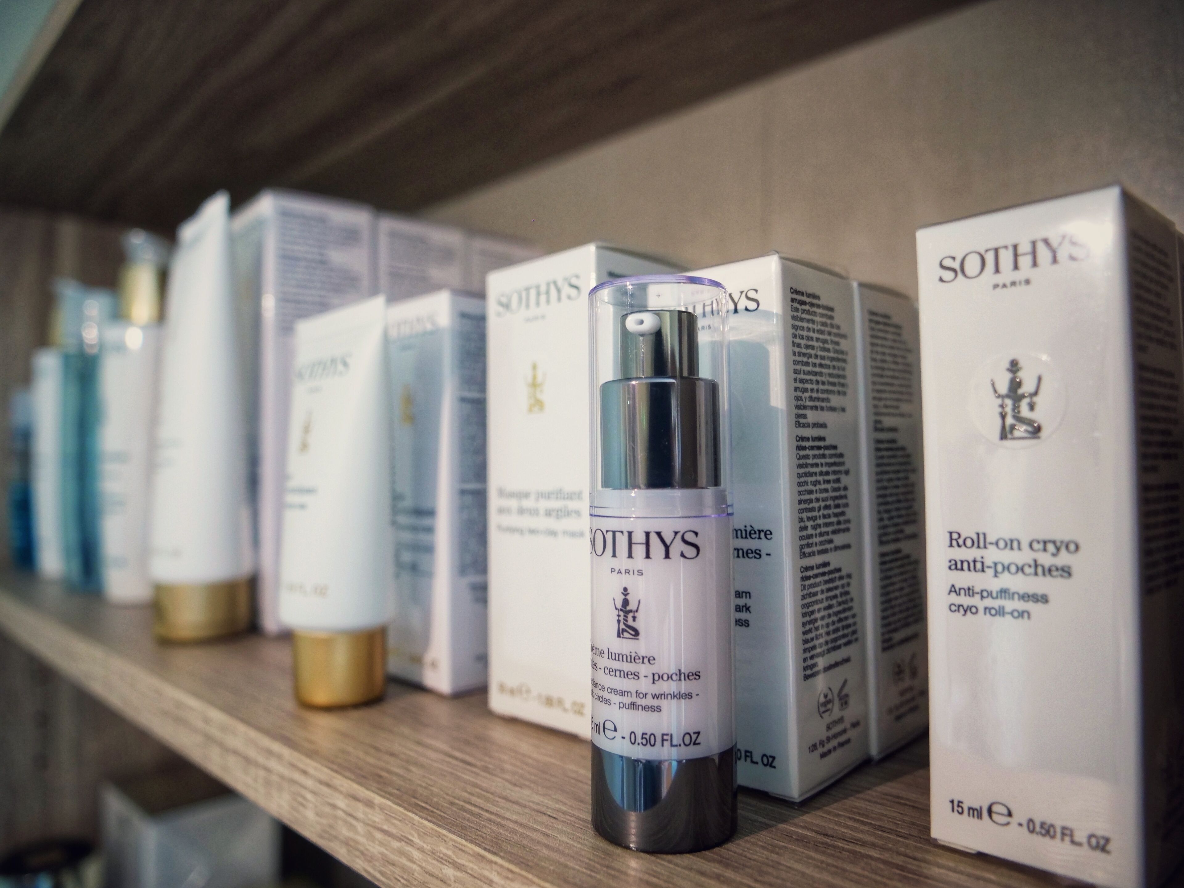 A shelf with various Sothys skincare products, including a spray bottle and boxes.