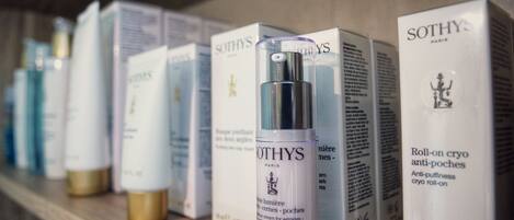 A shelf with various Sothys skincare products, including a spray bottle and boxes.