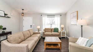 A living room with two sofas, a coffee table, and a lamp.