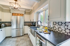 Enjoy cooking in this well-lit kitchen with a window, sink, and modern appliances.