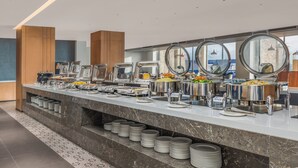 A buffet setup with multiple food stations and a marble counter.