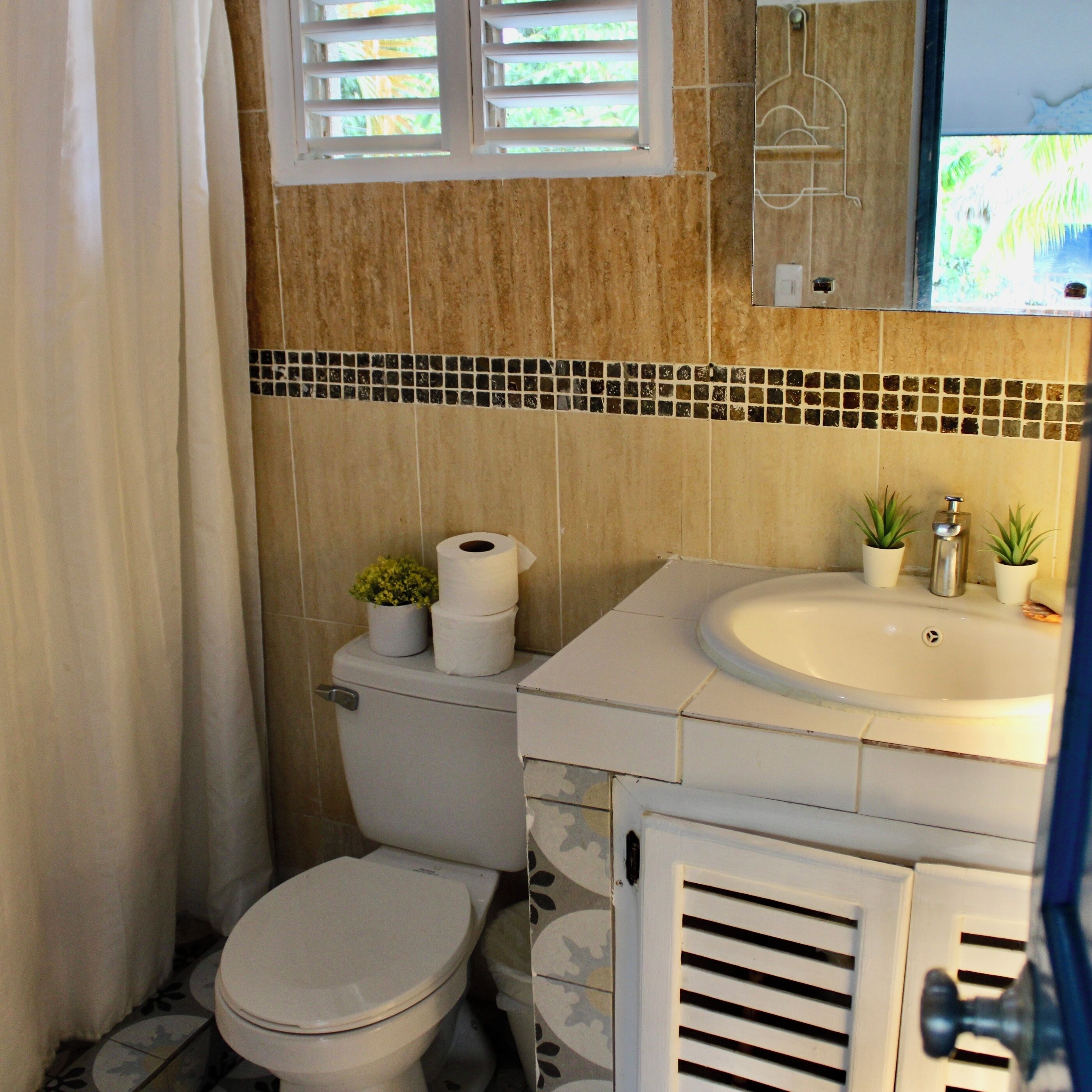 Un bagno con il water, il lavandino e la doccia.