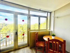 Enjoy a peaceful retreat with a balcony offering a serene view of the surrounding landscape.