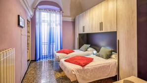 A bedroom with two beds, a wooden wardrobe, a radiator, and a window with a curtain. - 2 bedroom amazing home in Villanova d'Albenga (Villanova d'Albenga)