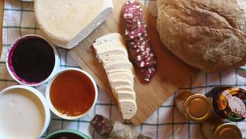 A variety of food items including cheese, bread, and condiments on a table.