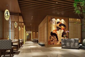 A hotel lobby with a traditional Asian decor, featuring a reception desk, seating area, and a decorative wall with cultural artwork. - Mingdu Hotel (Zhenjiang)