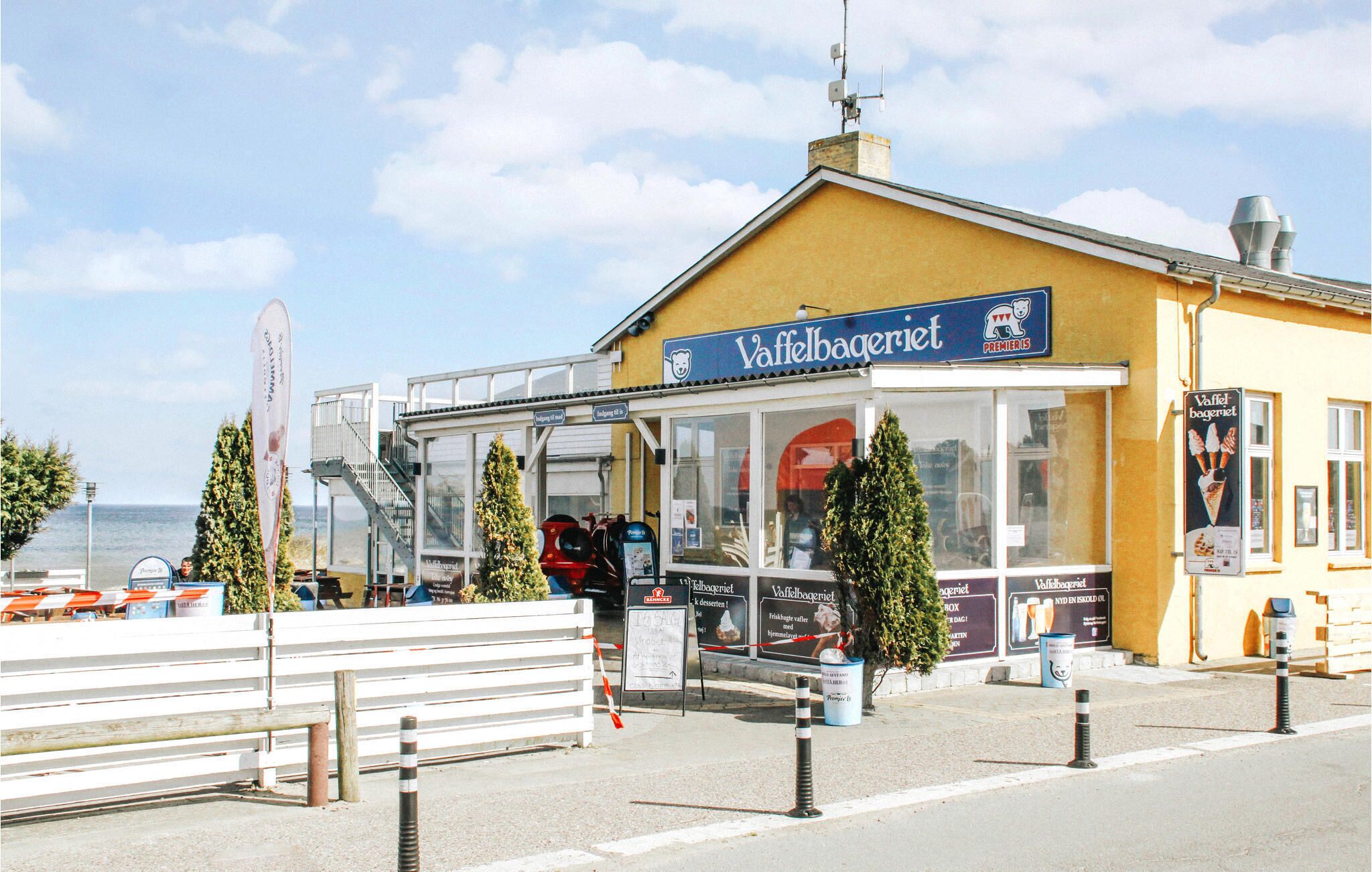 A storefront with a sign reading "Vaffelbageri" and a logo indicating "Premier".