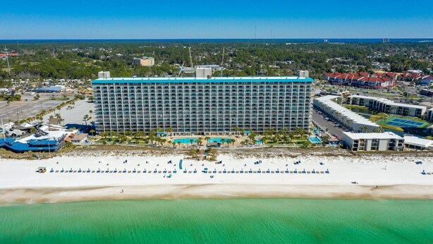A large hotel with a long building and a beach in front. - The Summit 712 (Panama City Beach)