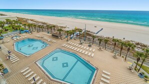 A resort with two large swimming pools, a beach, and a clear view of the ocean. - The Summit 712 (Panama City Beach)