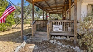 A wooden porch with a sign indicating a common area for tent guests.