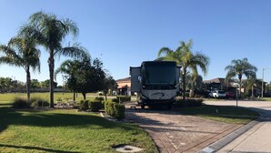 A residential street with a large truck parked on the side. - Motorhome Pad - Mt. Olive Shores North (Polk City)