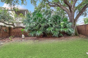 Enjoy a serene outdoor space surrounded by lush greenery and tropical plants.