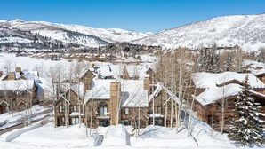 A snow-covered lodge with multiple buildings, surrounded by mountains and trees. - Beautiful Modern Home in Great Location, Hot Tub +Patio, Luxury Amenities! (Park City)