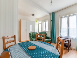 Relax in this serene space with a large window, a round table, and comfortable seating.