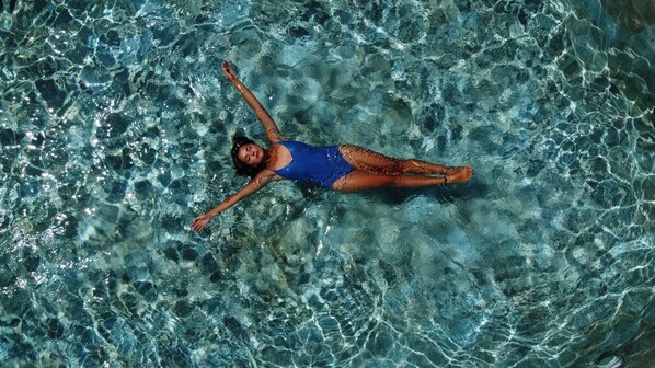 A person floating in clear water. - Aparthotel Eeb Ti Kaan Tulum - Luxury Condos. (Tulum)