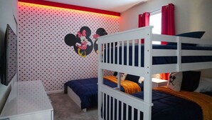 A child's bedroom with bunk beds, a dresser, and a Mickey Mouse wall decal. - Amazing 3 bedrooms condo in Resort with Water Park (Davenport)
