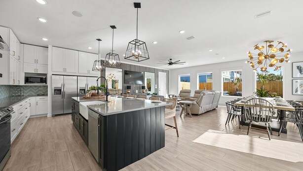 A modern kitchen with a central island, built-in appliances, and pendant lighting. - Fall is Near and the Most Wonderful time of year! (Panama City Beach)