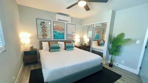 A bedroom with a bed, bedside tables, a ceiling fan, wall art, and a potted plant. - *Moonlight Cinema* - 15 min to Legoland! (Vista)