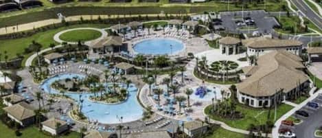 A resort with multiple swimming pools, a central courtyard, and surrounding villas.