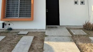 A modern two-story building with a black door and windows with orange frames. - Relaxing house with pool & self check-in (Mazatlán)