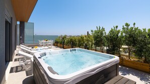 A hot tub on a deck with a view of the sea, outdoor furniture, and a wooden pergola. - Rhodes Skyline Suite with out Door Jacuzzi Sea View A2 (Rhodes)