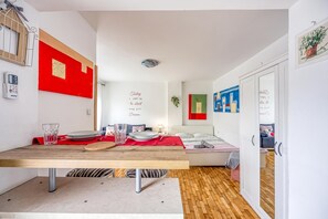 Een moderne woonruimte met een eethoek, een bed en een gang.