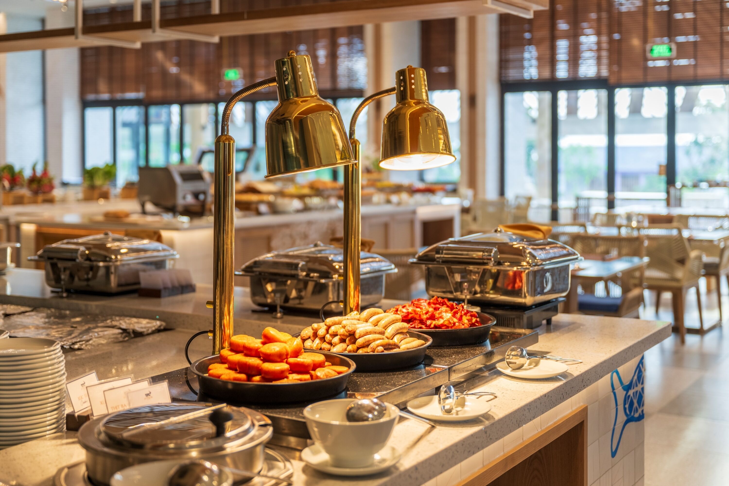 A buffet setup with various food items and buffet service equipment.