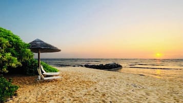 On the beach, sun loungers, beach towels