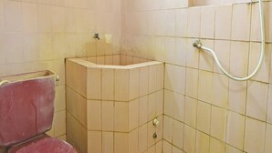 Een kleine badkamer met toilet, wastafel en douche.