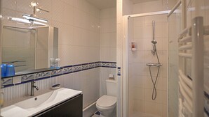 A bathroom with a sink, mirror, toilet, and shower. - Country house in a village with character (Saint-Galmier)