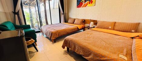 A hotel room with two beds, a green armchair, a large window, and a colorful abstract painting on the wall.