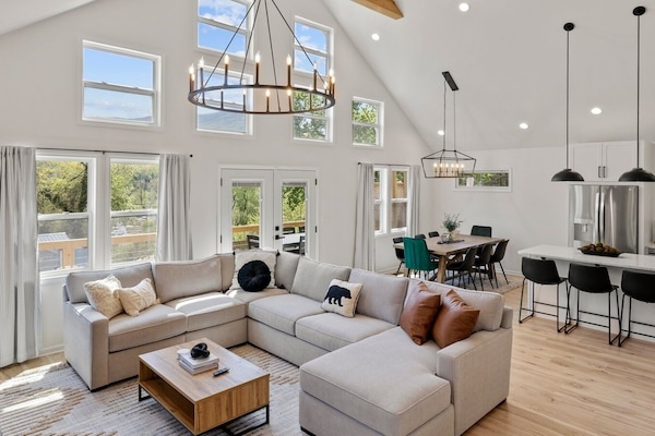 Relax in the large living and dining space where the vaulted ceilings and natural light create a calm and peaceful retreat after a long day of exploring.