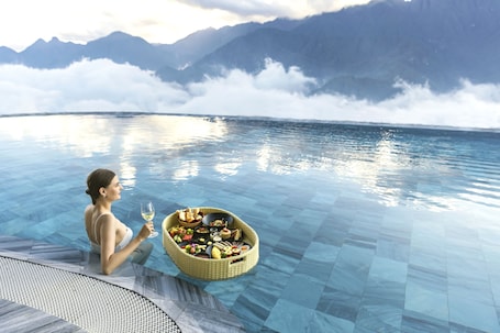 Indoor pool, outdoor pool, open 7:00 AM to 9:00 PM, pool umbrellas. Lady Hill Sapa Resort